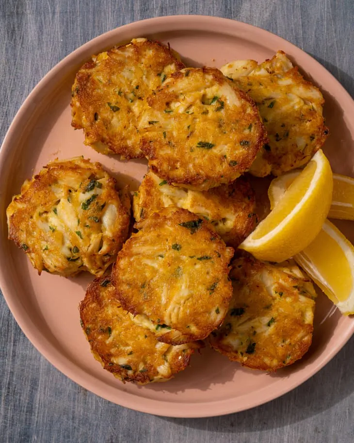 These baked crab cakes put the sweet and tender seafood front and center by leaving breading and filler to a minimum. (Kristina Vanni/TNS)