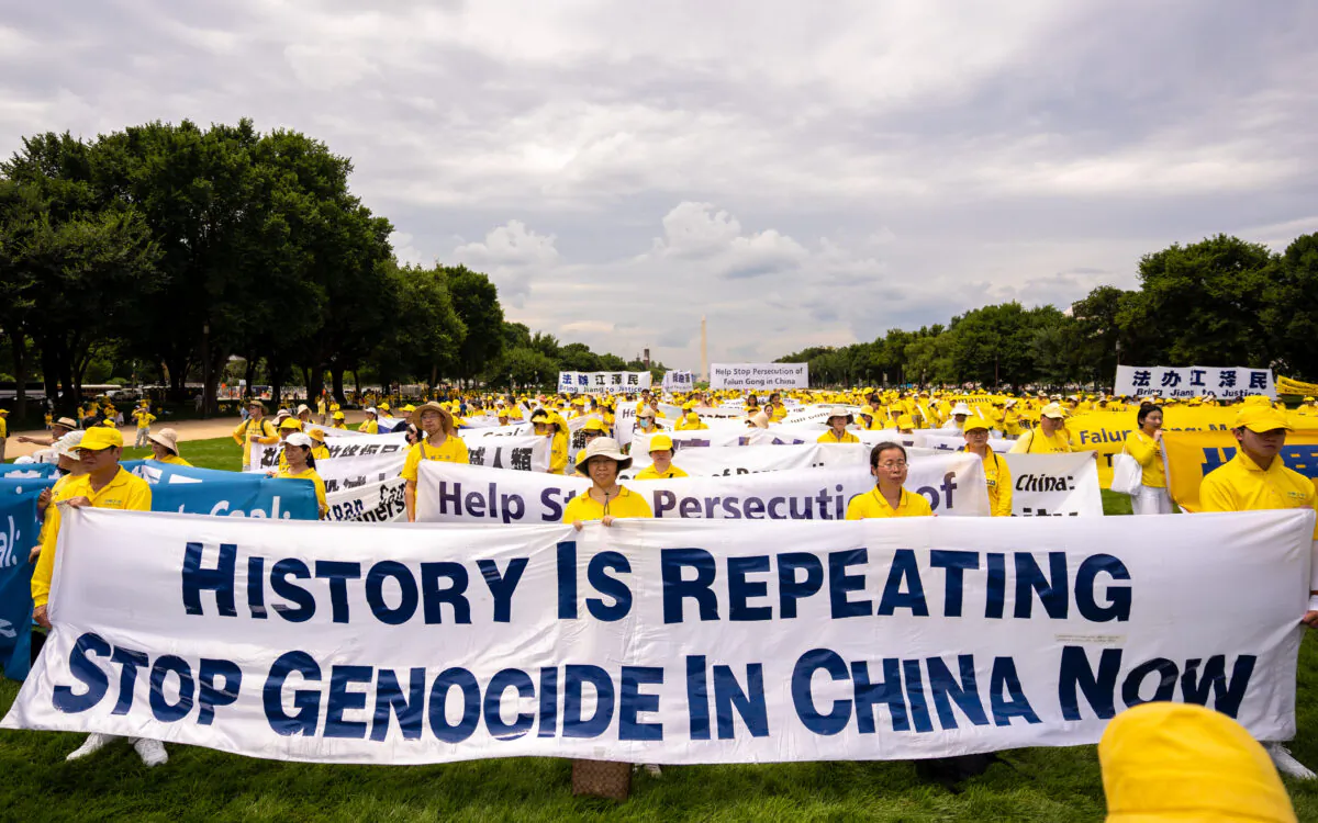 Falun Gong practitioners prepare to march down Pennsylvania Avenue to commemorate the 23rd anniversary of the Chinese Communist Party's persecution of the spiritual practice in China, in Washington on July 21, 2022. (Samira Bouaou/The Epoch Times)