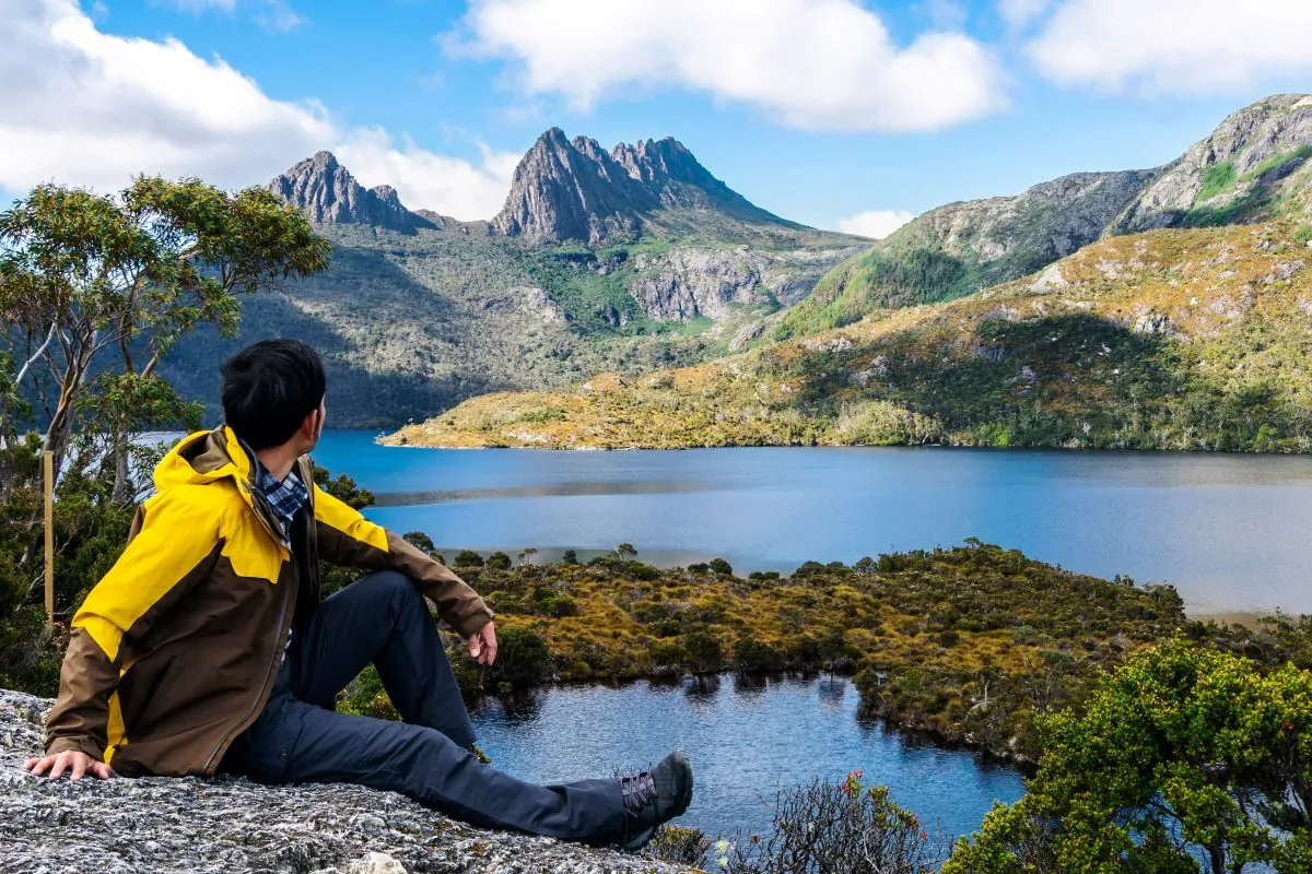Traveller taking in the view on the Marions lookout trail in Cradle Mountain National Park, Tasmania, Australia. (Blue Planet Studio/Adobe Stock)