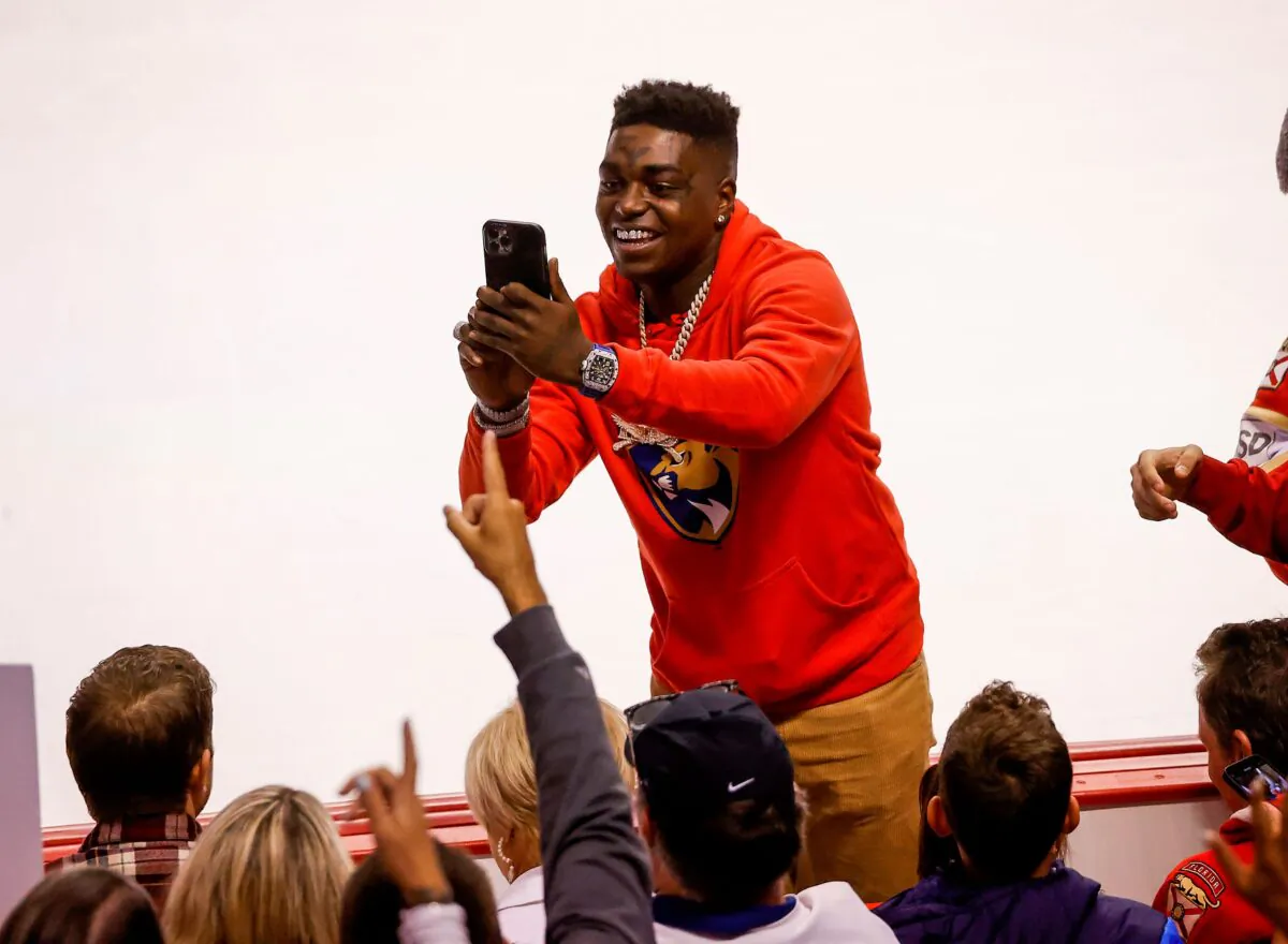 Rapper Kodak Black takes photos with fans during the third period of Game One of the First Round of the 2022 NHL Stanley Cup Playoffs between the Florida Panthers and the Washington Capitals at the FLA Live Arena in Sunrise, Fla., on May 3, 2022. (Joel Auerbach/Getty Images)