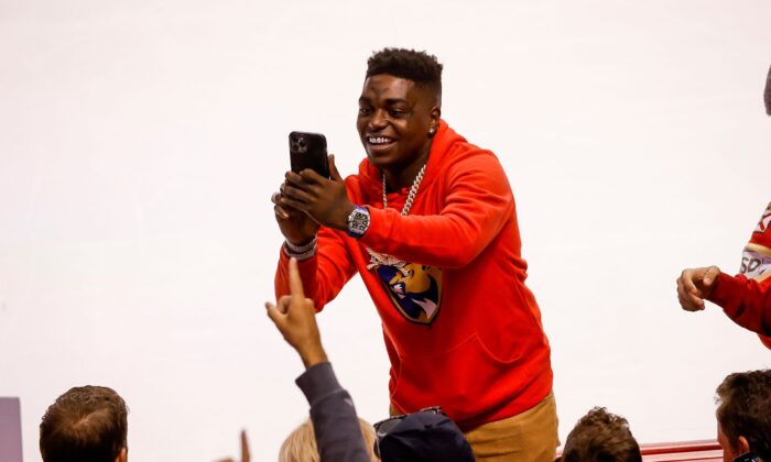 Rapper Kodak Black takes photos with fans during the third period of Game One of the First Round of the 2022 NHL Stanley Cup Playoffs between the Florida Panthers and the Washington Capitals at the FLA Live Arena in Sunrise, Fla., on May 3, 2022. (Joel Auerbach/Getty Images)