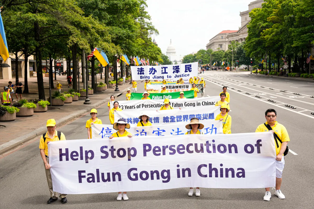 Falun Gong practitioners march down Pennsylvania Avenue to commemorate the 23rd anniversary of the Chinese Communist Party's persecution of the spiritual practice in China, in Washington on July 21, 2022. (Larry Dye/ The Epoch Times)