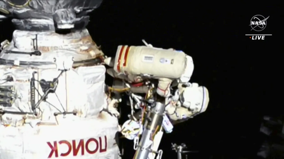 This image provided by NASA, Italian astronaut Samantha Cristoforetti and Russian cosmonaut Oleg Artemyev perform maintenance on the International Space Station on July 21, 2022. (NASA via AP).