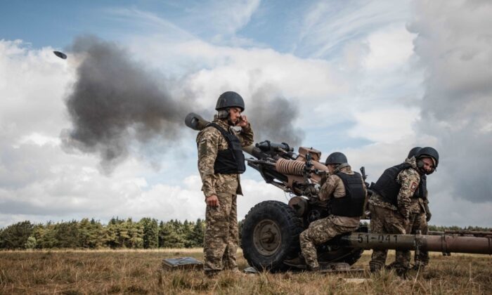 Undated handout photo of an artillery gun being fired, issued by the UK Ministry of Defence on June 25, 2022. (UK Ministry of Defence/PA Media)
