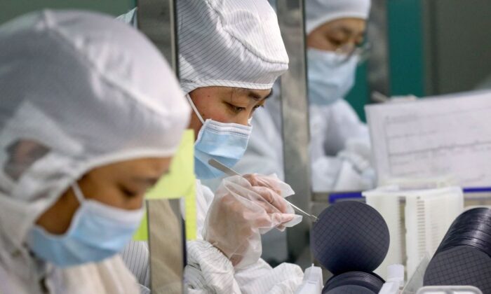 Employees make chips at a factory of Jiejie Semiconductor Company in Nantong, in eastern China's Jiangsu Province, on March 17, 2021. (STR/AFP via Getty Images)
