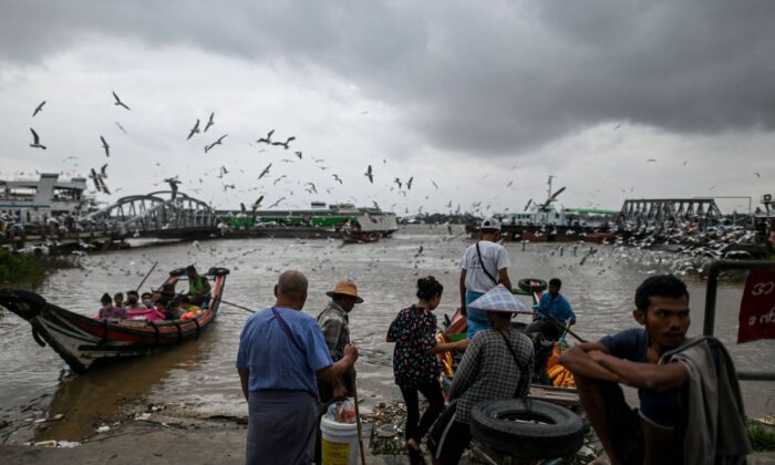 People board a ferry boat in Yangon River in Yangon on March 22, 2022. (AFP via Getty Images)