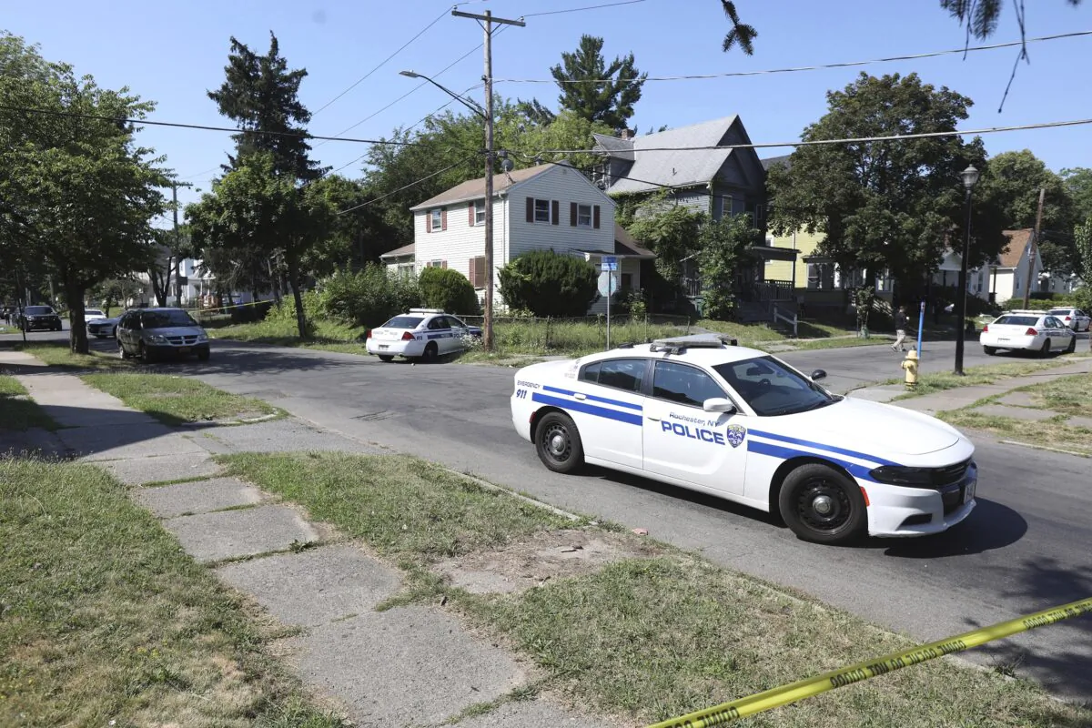 Rochester police collect evidence in the area of Bauman and Laser Streets where two officers were shot last night, in Rochester, N.Y., on July 22, 2022. (Tina MacIntyre-Yee/Democrat & Chronicle via AP)
