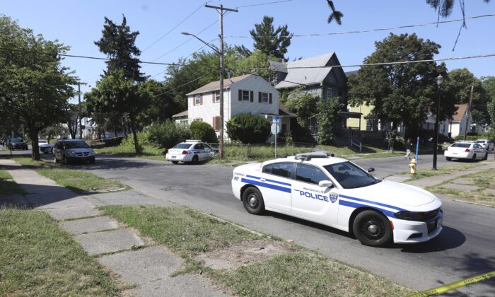 Rochester police collect evidence in the area of Bauman and Laser Streets where two officers were shot last night, in Rochester, N.Y., on July 22, 2022. (Tina MacIntyre-Yee/Democrat & Chronicle via AP)