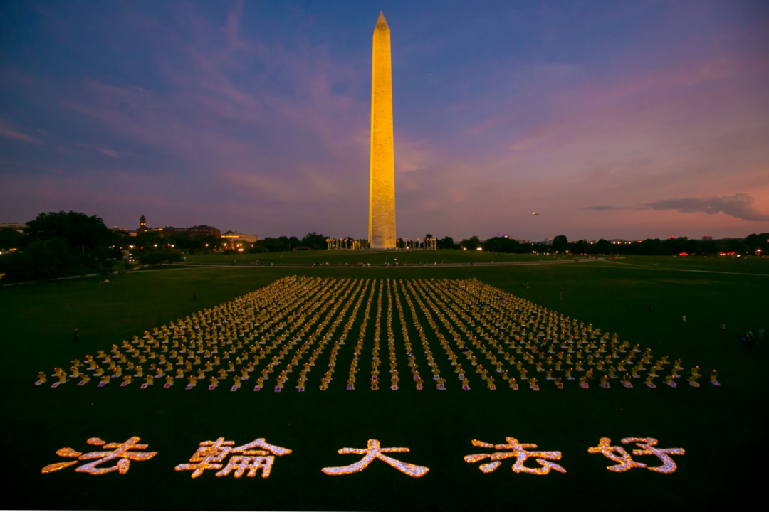 Over a thousand Falun Gong practitioners hold a candlelight vigil at the Washington Monument on July 21, 2022. (Lisa Fan/The Epoch Times)