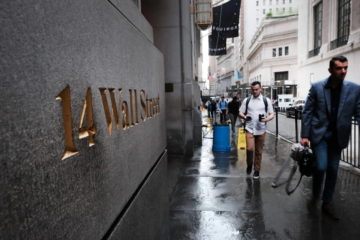 People walk by the New York Stock Exchange (NYSE), on June 14, 2022, in New York City. (Spencer Platt/Getty Images)