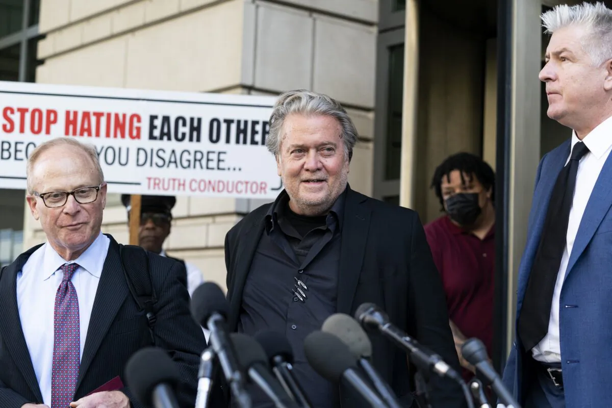 Former White House strategist Steve Bannon, center, walks to speak with reporters as he departs federal court in Washington on July 22, 2022. (Alex Brandon/AP Photo)