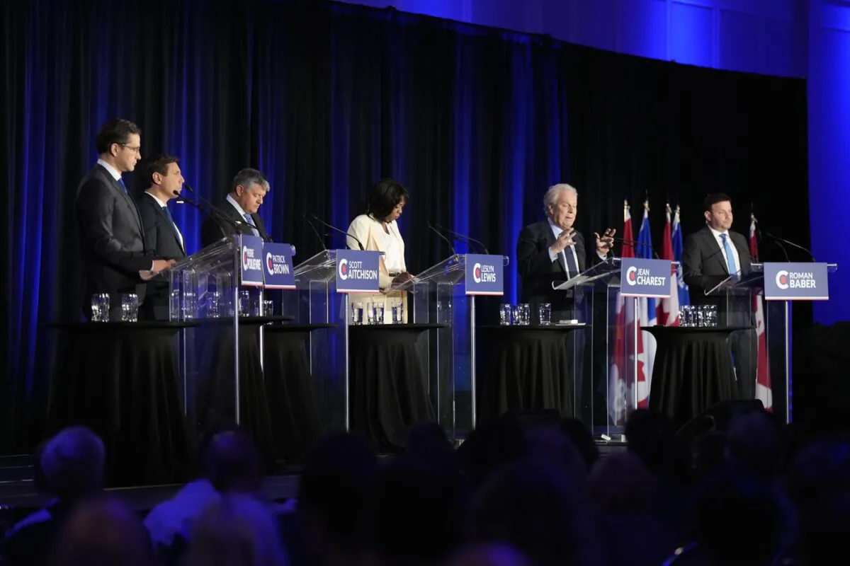 Conservative leadership hopeful Jean Charest, second right, speaks as Pierre Poilievre, left to right, Patrick Brown, Scott Aitchison, Leslyn Lewis, and Roman Baber look on during the Conservative Party of Canada French-language leadership debate in Laval, Quebec on May 25, 2022. (The Canadian Press/Ryan Remiorz)