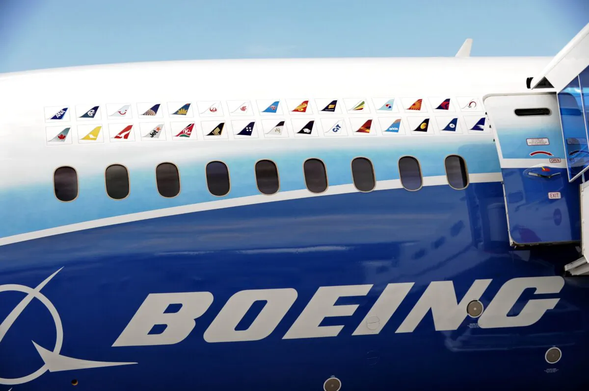 Various flight carrier logos are painted on the Boeing 787 Dreamliner at the Singapore Airshow in Singapore on Feb. 12, 2012. (Roslan Rahman/AFP via Getty Images)