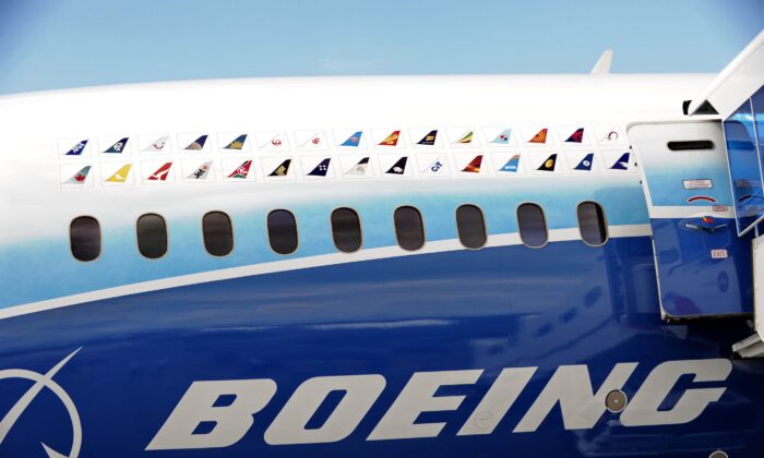 Various flight carrier logos are painted on the Boeing 787 Dreamliner at the Singapore Airshow in Singapore on Feb. 12, 2012. (Roslan Rahman/AFP via Getty Images)
