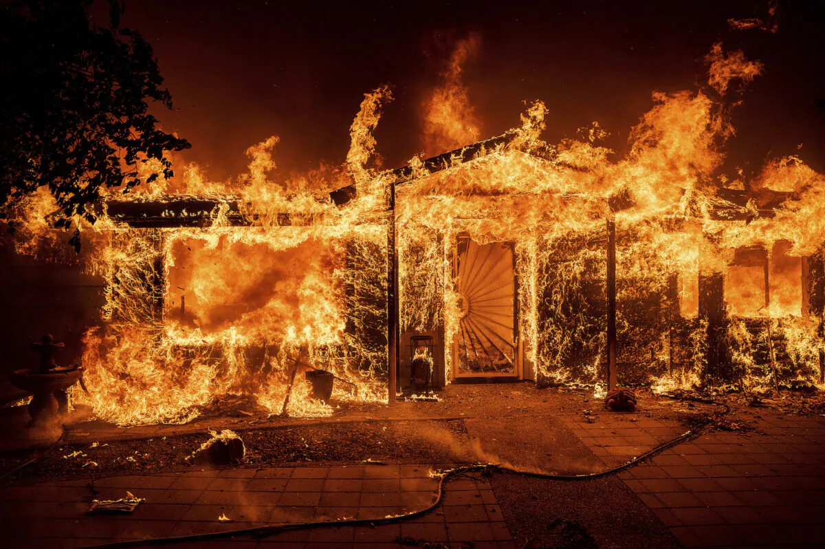 Flames consume a home on Triangle Rd. as the Oak Fire burns in Mariposa County, Calif., on July 23, 2022. (Noah Berger/AP Photo)