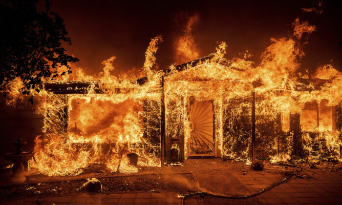 Flames consume a home on Triangle Rd. as the Oak Fire burns in Mariposa County, Calif., on July 23, 2022. (Noah Berger/AP Photo)