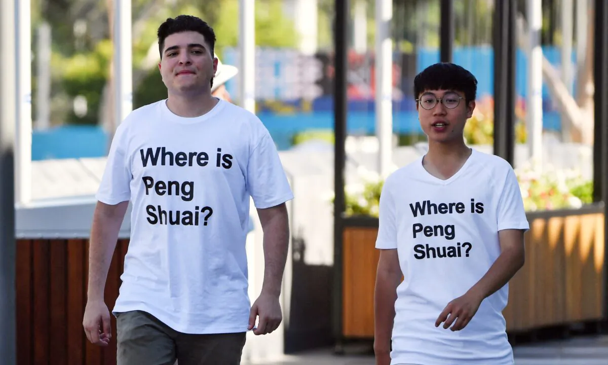 Australian human rights campaigner Drew Pavlou (L) is pictured wearing a "Where is Peng Shuai?" T-shirt, referring to the former doubles world number one from China, on the grounds outside one of the venues on day nine of the Australian Open tennis tournament in Melbourne on Jan. 25, 2022. (Paul Crock/AFP via Getty Images)