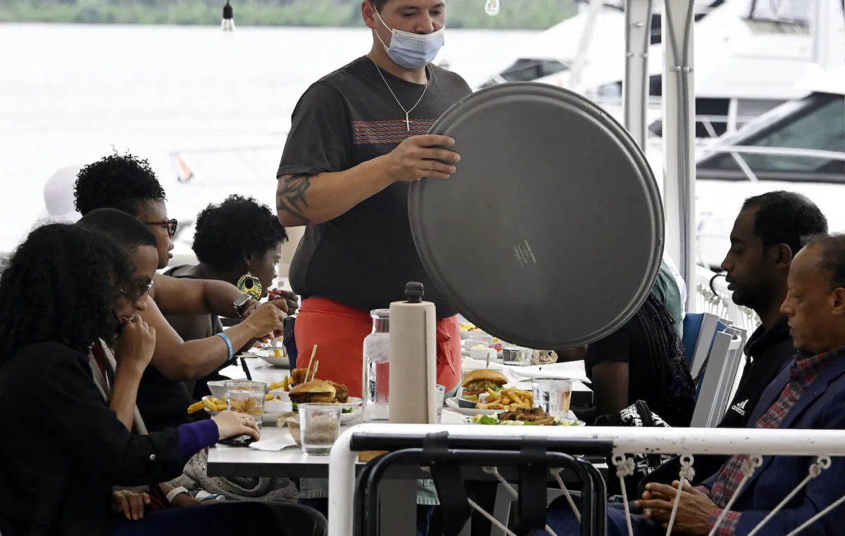 A waiter works at a restaurant in Alexandria, Virginia on June 3, 2022. (Olivier Douliery/AFP via Getty Images)