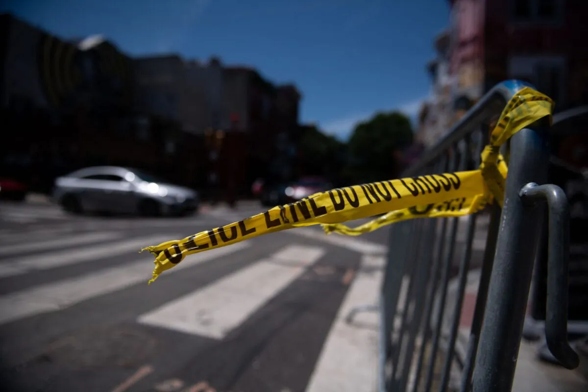 Police tape hangs from a barricade at the corner of South and 3rd Streets the day after three people were killed and 11 others wounded by gunfire all within a few blocks, in Philadelphia, Pennsylvania, on June 5, 2022. (Kriston Jae Bethel/AFP via Getty Images)