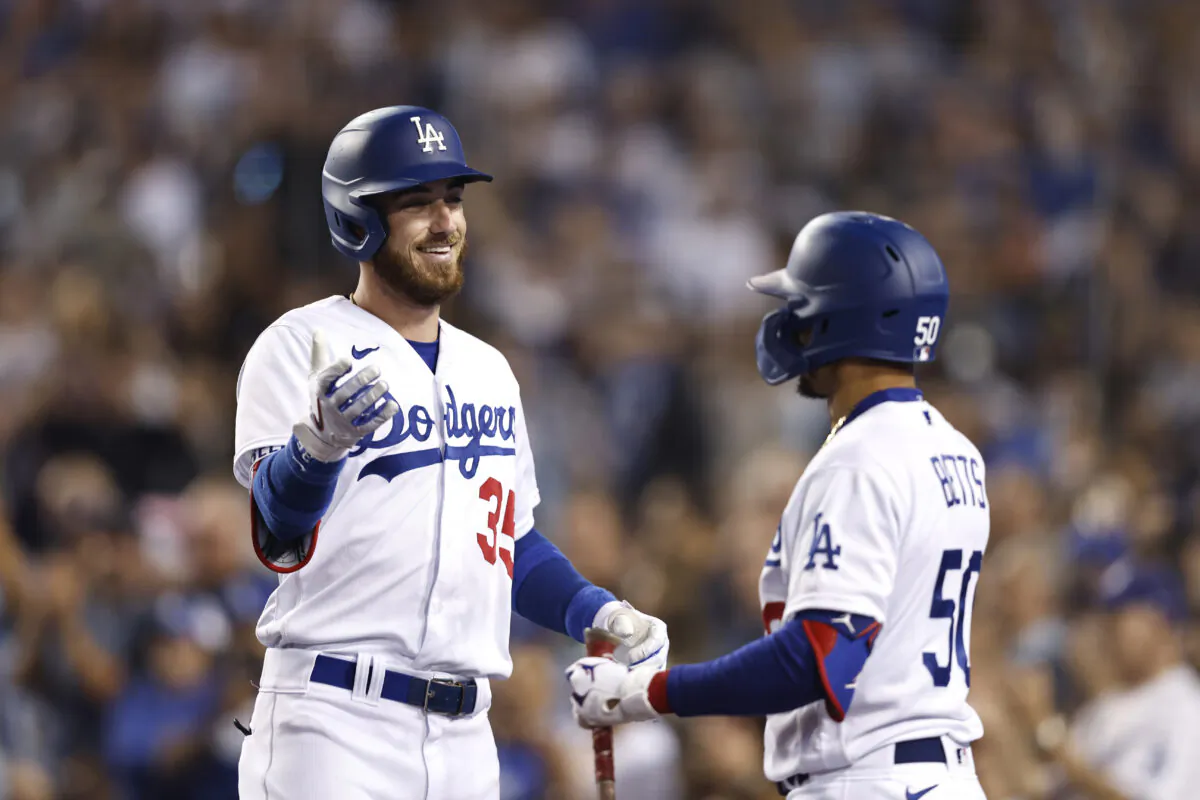 Cody Bellinger #35 of the Los Angeles Dodgers celebrates with Mookie Betts #50 after hitting a grand slam against the San Francisco Giants during the eighth inning at Dodger Stadium, in Los Angeles, on July 22, 2022. (Michael Owens/Getty Images)