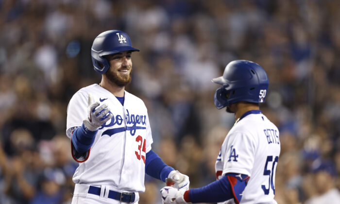 Cody Bellinger #35 of the Los Angeles Dodgers celebrates with Mookie Betts #50 after hitting a grand slam against the San Francisco Giants during the eighth inning at Dodger Stadium, in Los Angeles, on July 22, 2022. (Michael Owens/Getty Images)