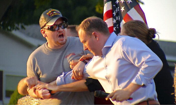 David Jakubonis (L) is subdued as he brandishes a sharp object during an attack on Rep. Lee Zeldin (R-N.Y.) as the Republican candidate for New York governor delivers a speech in Perinton, N.Y., on July 21, 2022, in this image taken from video. (WHEC-TV via AP)
