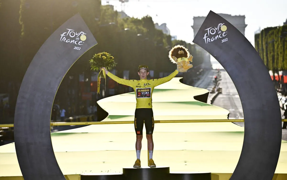 Jumbo-Visma team's Danish rider Jonas Vingegaard celebrates on the podium with the overall leader's yellow jersey after winning the 109th edition of the Tour de France cycling race, after the 21st and final 115,6 km stage between La Defense Arena in Nanterre, outside Paris, and the Champs-Elysees in Paris on July 24, 2022. (Anne-Christine Poujoulat/AFP via Getty Images)