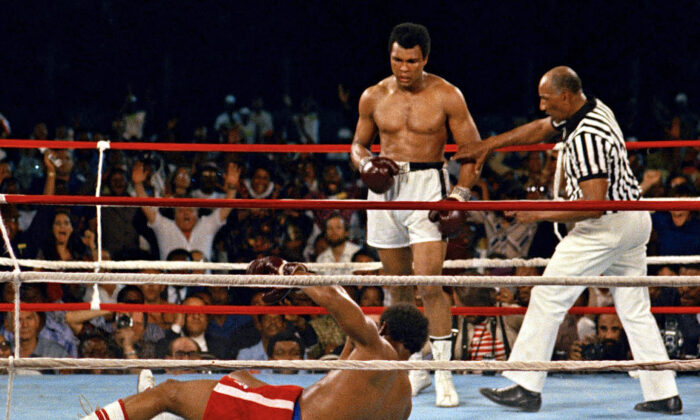 Referee Zack Clayton (R) steps in after challenger Muhammad Ali (C) knocked down defending heavyweight champion George Foreman (L) in the eighth round of their championship bout in Kinshasa, Zaire, Republic of the Congo, on Oct. 30, 1974. (AP Photo)