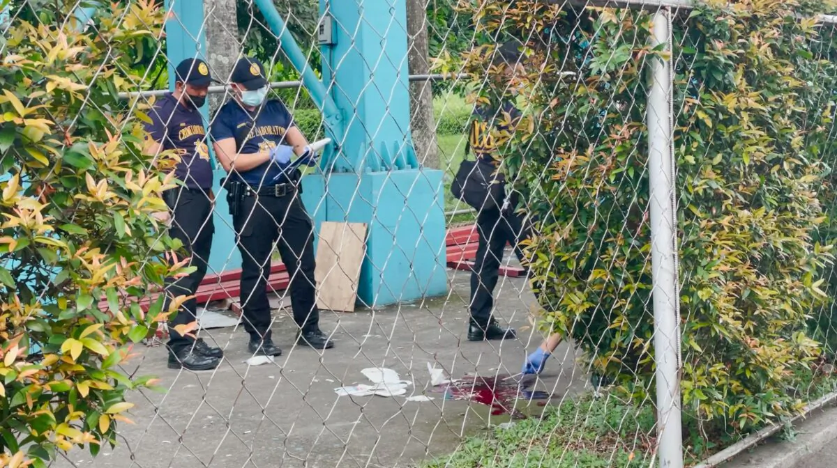 Police investigators inspect the crime scene after a shooting at the Ateneo de Manila University, in Quezon City, Metro Manila, Philippines, on July 24, 2022. (Adrian Portugal/Reuters)