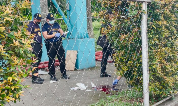 Police investigators inspect the crime scene after a shooting at the Ateneo de Manila University, in Quezon City, Metro Manila, Philippines, on July 24, 2022. (Adrian Portugal/Reuters)