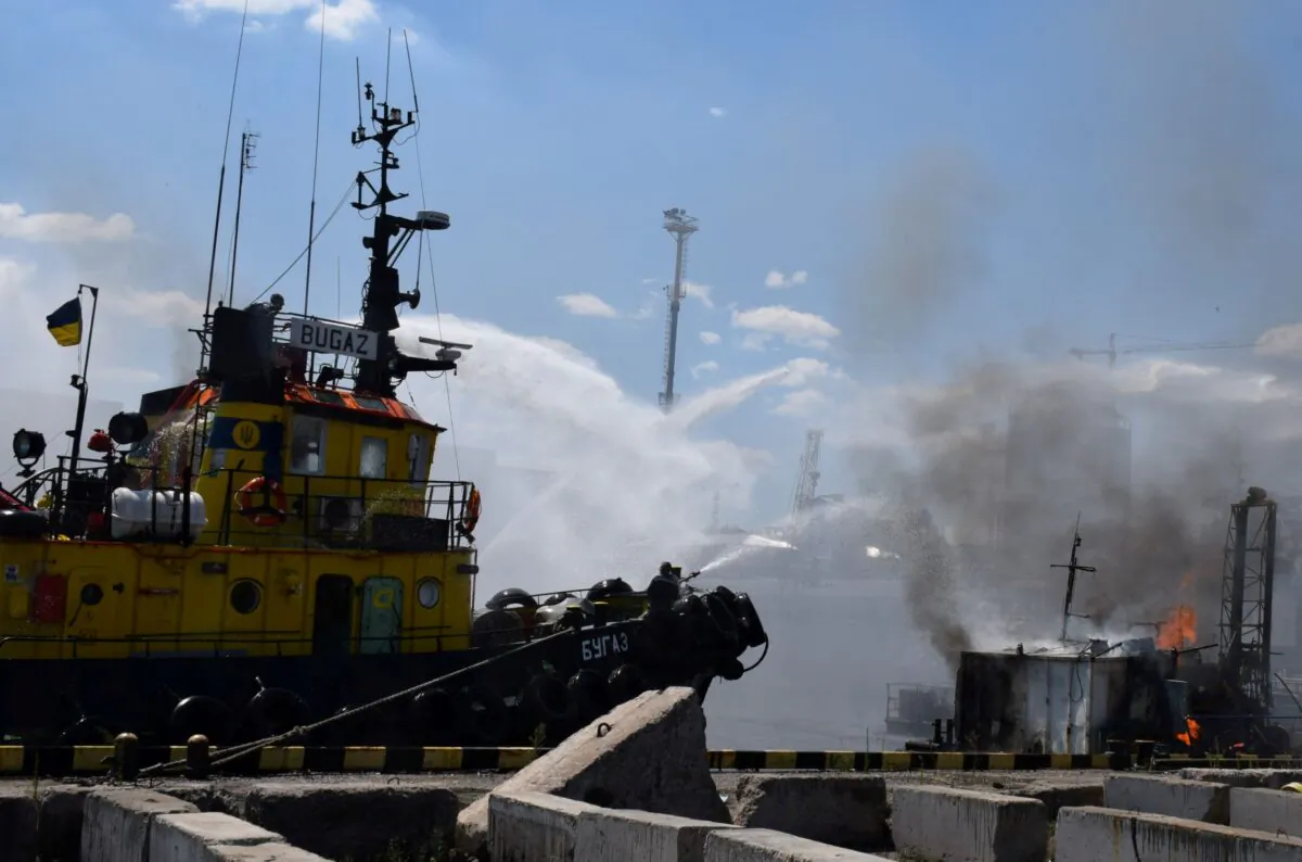 Firefighters work at a site of a Russian missile strike in a sea port of Odesa, Ukraine, on July 23, 2022. (Press service of the Joint Forces of the South Defense/Handout via Reuters)