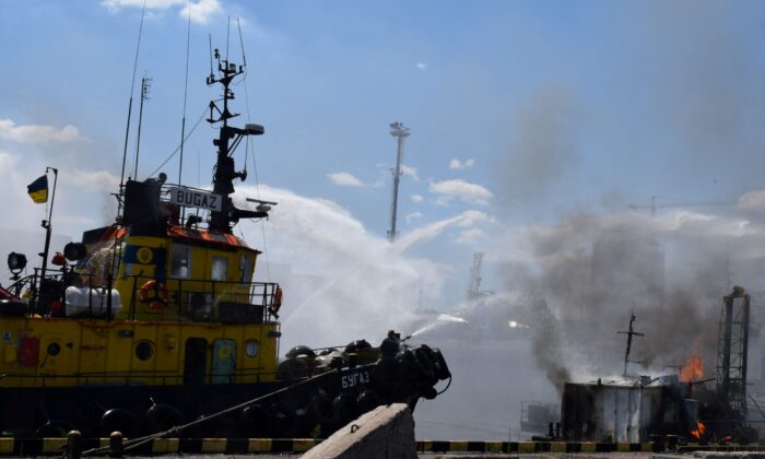 Firefighters work at a site of a Russian missile strike in a sea port of Odesa, Ukraine, on July 23, 2022. (Press service of the Joint Forces of the South Defense/Handout via Reuters)