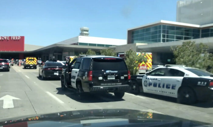 Emergency response vehicles and police cars outside Dallas Love Field Airport after shots were fired on July 25, 2022. (CNN/Screenshot via NTD)