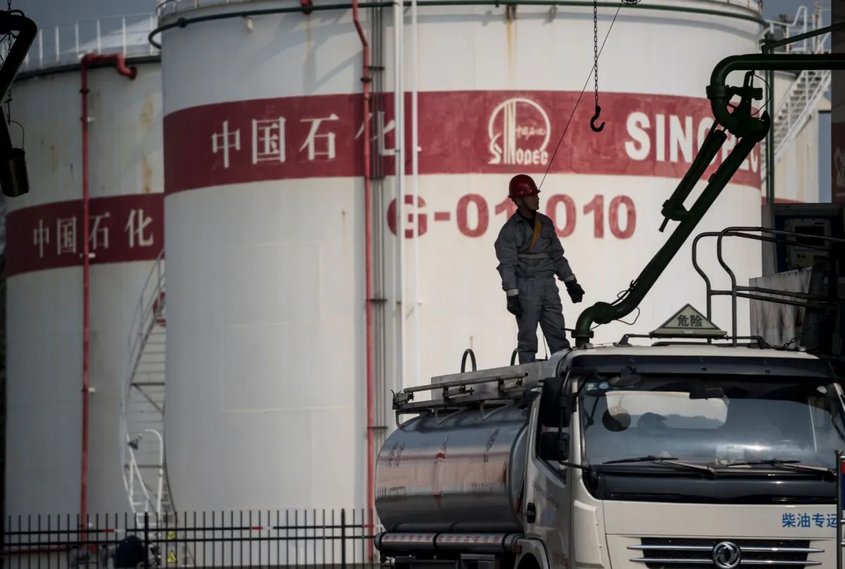 A man works in a filling station of Sinopec, China Petroleum and Chemical Corporation, in Shanghai on March 22, 2018.
(Johannes Eisele/AFP via Getty Images)