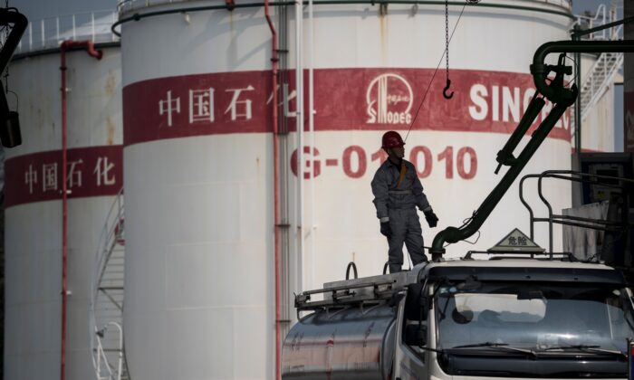 A man works in a filling station of Sinopec, China Petroleum and Chemical Corporation, in Shanghai on March 22, 2018. 
(Johannes Eisele/AFP via Getty Images)