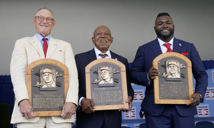 From left to right, National Baseball Hall of Fame inductees Jim Kaat, Tony Oliva and David Ortiz, hold their plaques during the Hall of Fame induction ceremony at the Clark Sports Center in Cooperstown, N.Y., on  Sunday, July 24, 2022.  (John Minchillo/AP Photo)