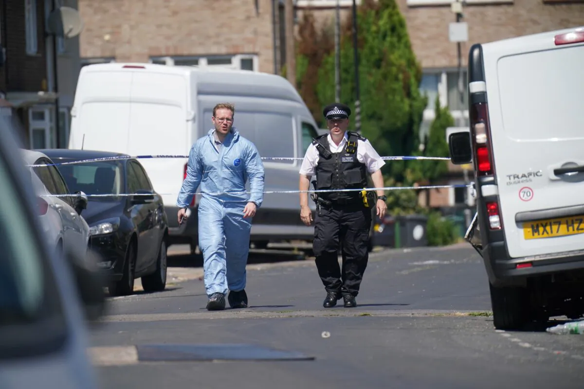 Police near the scene where a 28-year-old man died after a shooting at a gathering in Waltham Forest, in east London, on July 24, 2022. (Jonathan Brady/PA Media)