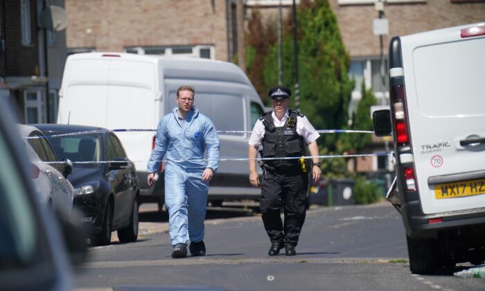Police near the scene where a 28-year-old man died after a shooting at a gathering in Waltham Forest, in east London, on July 24, 2022. (Jonathan Brady/PA Media)
