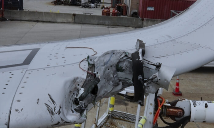The left wingtip damage and portion of distance remaining marker support structure lodge in wingtip that was damaged during an accident in New York's John F. Kennedy International Airport, on April 10, 2019. (American Airlines via AP)