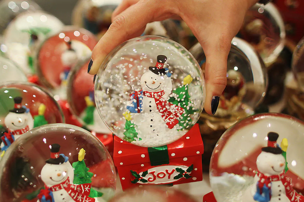 An employee holds a decoration in the Christmas shop at Selfridges department store in London, England, on July 28, 2011. (Dan Kitwood/Getty Images)