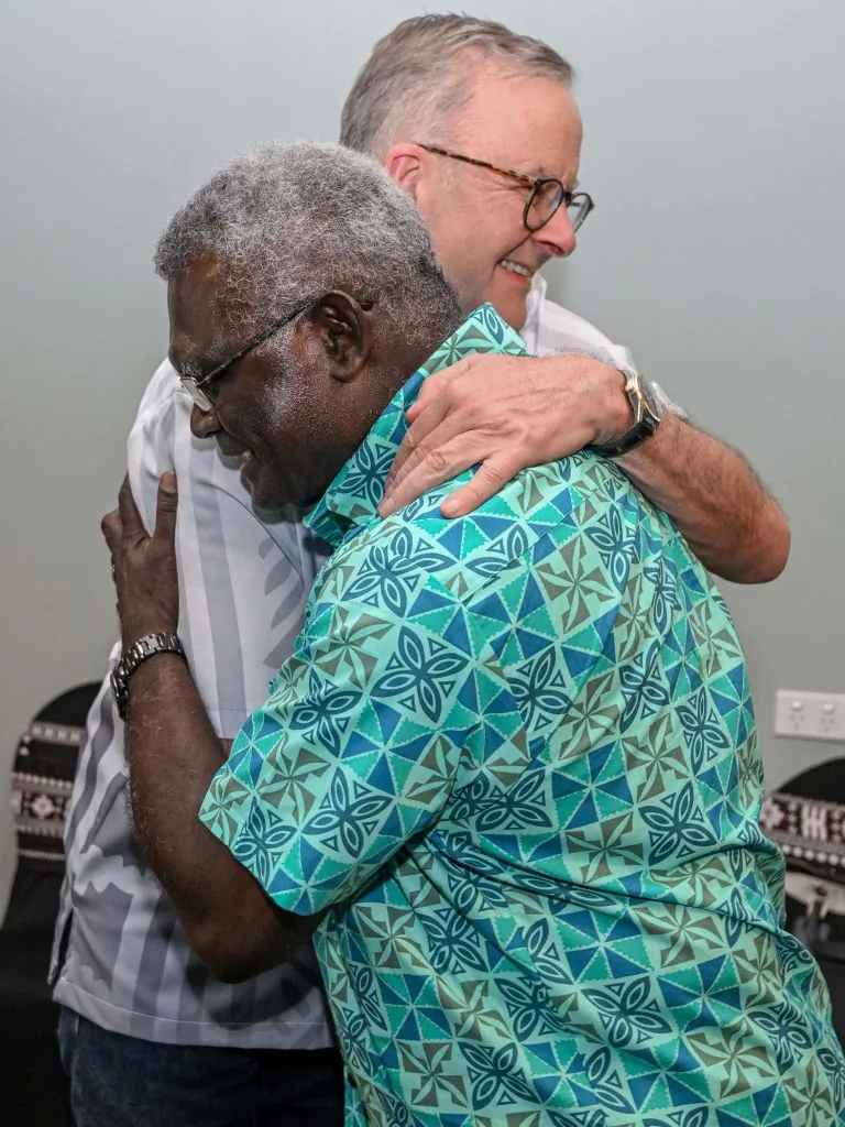 Australia's Prime Minister Anthony Albanese (L) hugs Solomon Islands Prime Minister Manasseh Sogavare as they meet for a bilateral meeting at the Pacific Islands Forum (PIF) in Suva, Fiji on July 13, 2022. (Joe Armao/POOL/AFP via Getty Images)