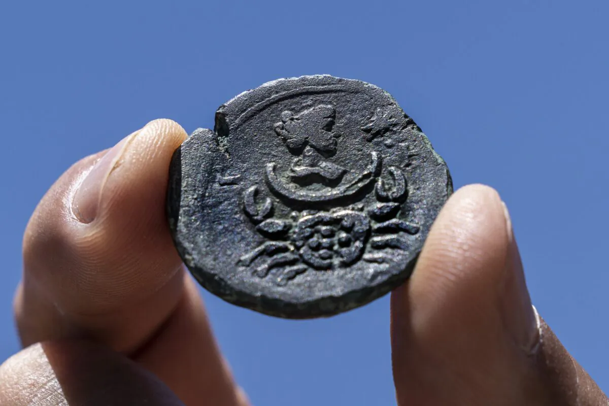 A rare, nearly 1,850-year-old bronze coin discovered off the Israeli coastal city of Haifa is on display at Israel's Antiquities Authority office in Jerusalem, on July 26, 2022. (Tsafrir Abayov/AP Photo)