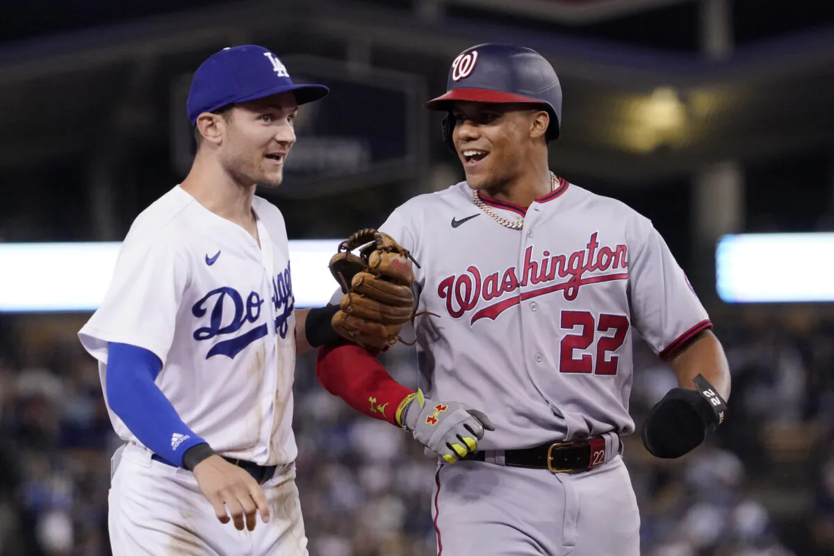 Los Angeles Dodgers' Trea Turner, left, and Washington Nationals' Juan Soto joke around after the end of the top of the seventh inning of a baseball game, in Los Angeles, on Monday, July 25, 2022. (Mark J. Terrill/AP Photo)