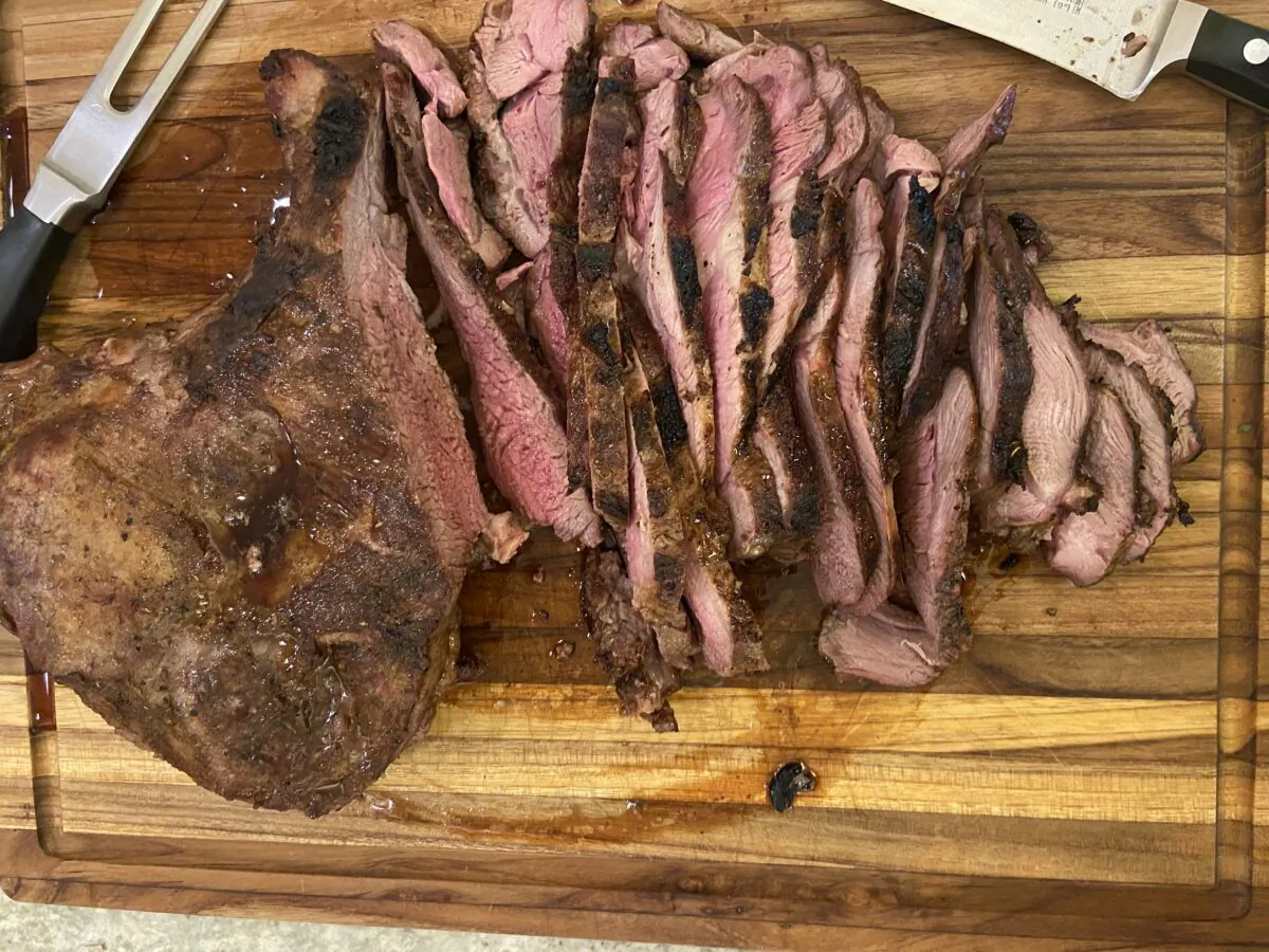 Serve the grilled lamb with a spicy green condiment to dab onto the sliced meat. (JeanMarie Brownson/TNS)