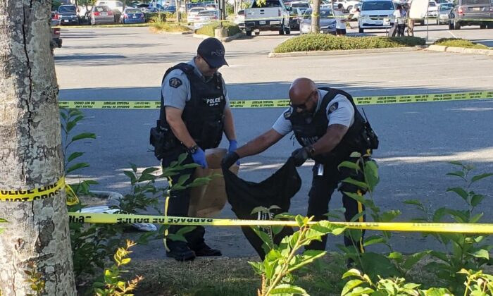 Police collect evidence at the site of the shootings in Langley on July 25, 2022. (Jeff Sandes/The Epoch Times)
