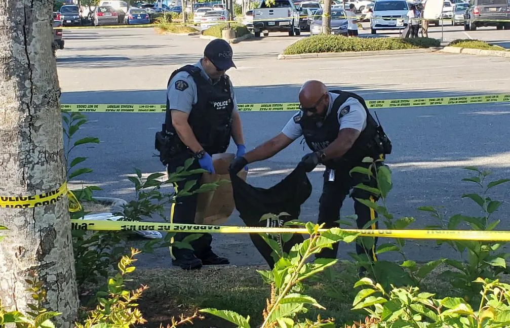 Police collect evidence at the site of the shootings in Langley on July 25, 2022. (Jeff Sandes/The Epoch Times)