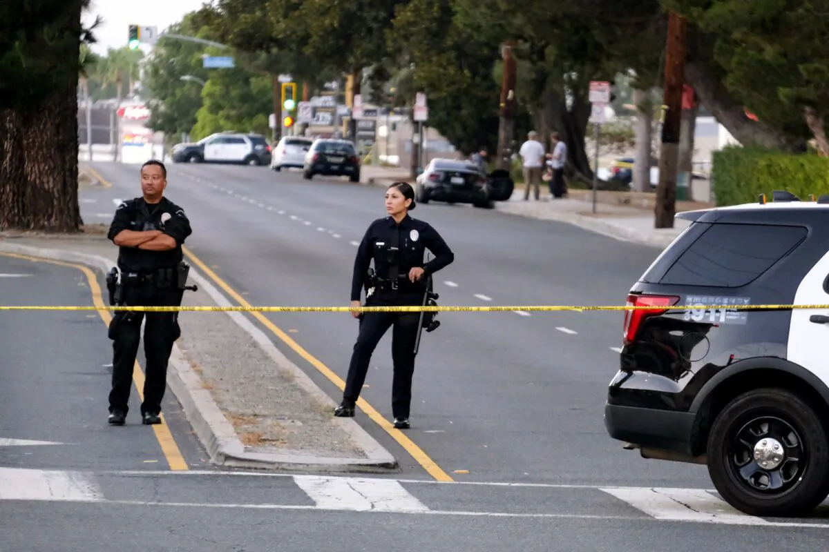 Police officers stand near the scene of a shooting at Peck Park in San Pedro, Calif., on July 24, 2022. (Ringo H.W. Chiu/AP Photo)