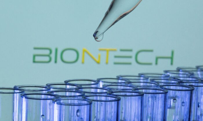 Test tubes in front of a displayed Biontech logo in this illustration taken on May 21, 2021. (Dado Ruvic/Illustration/Reuters)