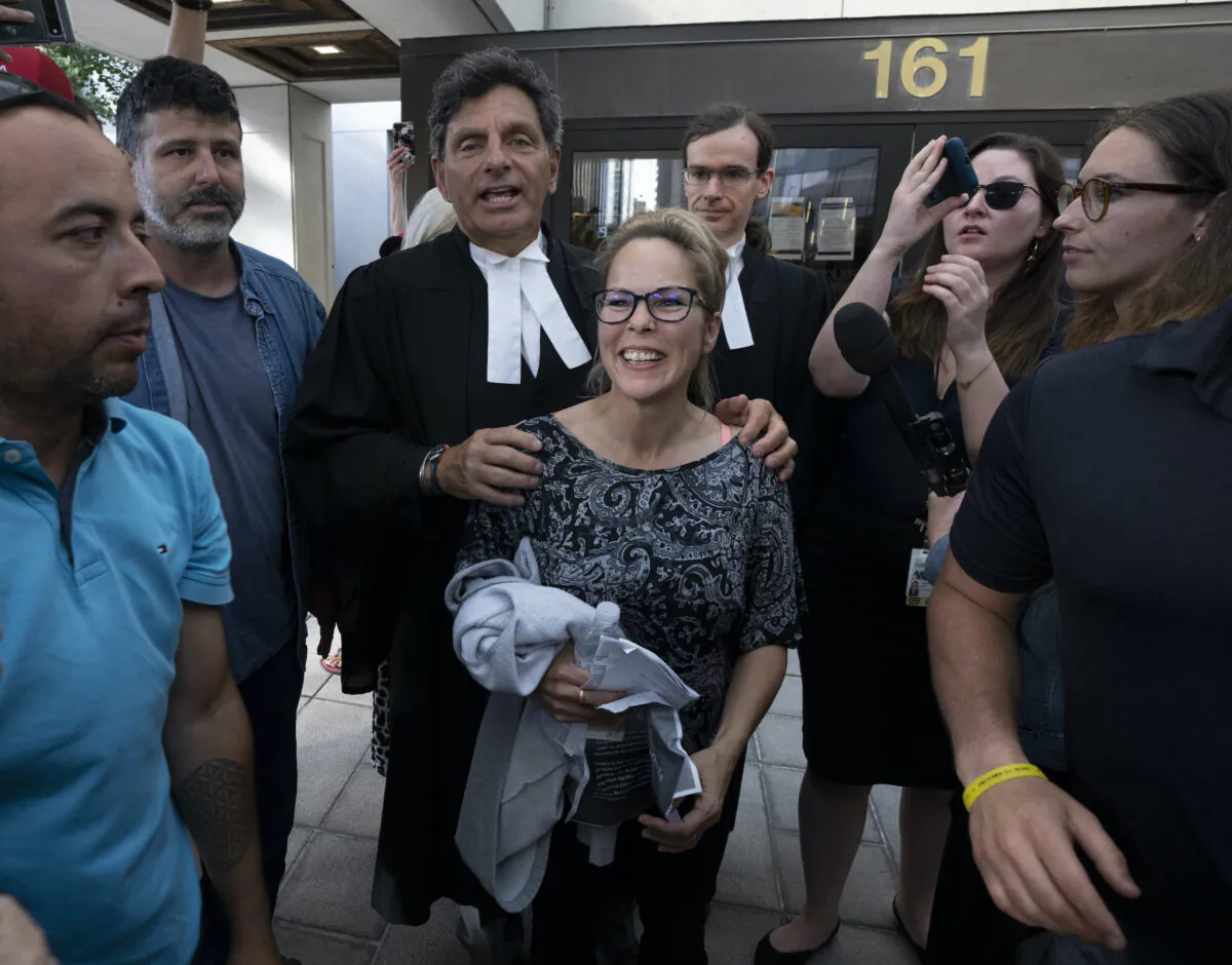 Freedom Convoy organizer Tamara Lich stands with her lawyer Lawrence Greenspon as they leave the courthouse after Lich was released on bail, in Ottawa on July 26, 2022. (The Canadian Press/Adrian Wyld)