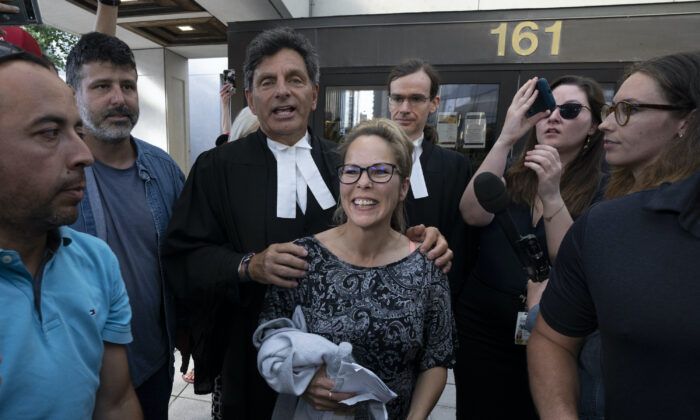 Freedom Convoy organizer Tamara Lich stands with her lawyer Lawrence Greenspon as they leave the courthouse after Lich was released on bail, in Ottawa on July 26, 2022. (The Canadian Press/Adrian Wyld)